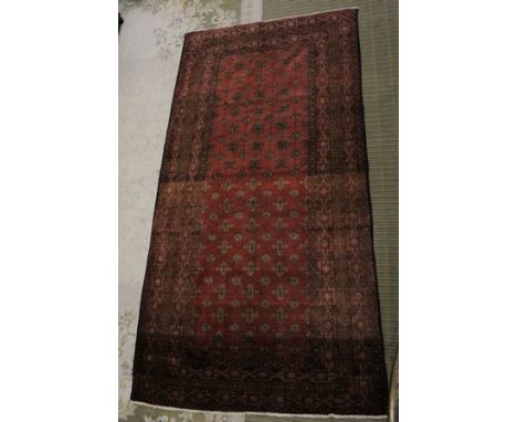 AN ANTIQUE NOMADIC TRIBE HAND-WOVEN CARPET, having allover typical geometric pattern with haphazard usage of colours, predomi