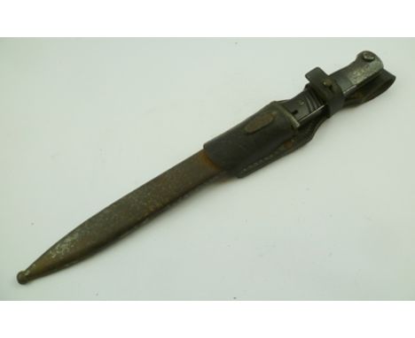 A GERMAN WORLD WAR II BAYONET in scabbard with leather frog, no.3207 on blade and scabbard, frog dated 1942, blade 25cm long 
