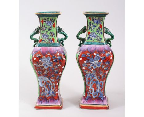 A PAIR OF 18TH CENTURY KANGXI CHINESE BLUE &amp; WHITE CLOBBERED PORCELAIN VASES, decorated in a variety of colour and depict