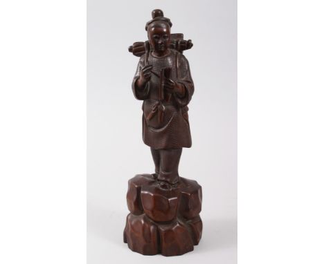 A GOOD CHINESE 19TH CENTURY HARDWOOD FIGURE OF A BOY, modeled holding a quill and scroll, his pack upon his back, stood on a 