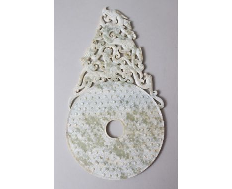 A GOOD 19TH / 20TH CENTURY CHINESE SNOWFLAKE JADE DRAGON BI DISK / SCREEN, carved with dragons and raised cloud swirls, 28cm 