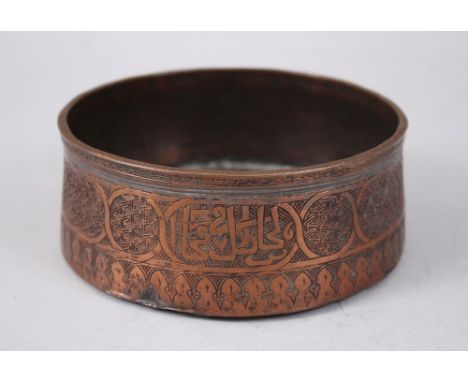 A RARE 15TH CENTURY MAMLUK ENGRAVED COPPER CIRCULAR BOWL, the sides with calligraphy, 14cm diameter x 5.5cm high.