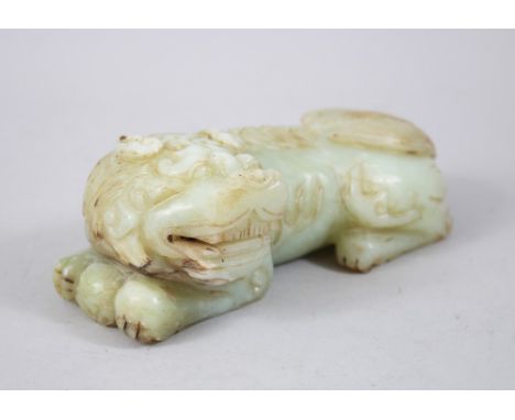 A GOOD 19TH / 20TH CENTURY CHINESE CARVED JADE LION DOG, the dog recumbent, 5.5cm high x 16cm wide.