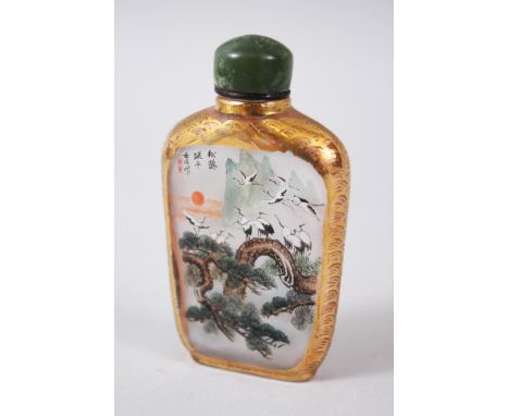 A CHINESE 20TH CENTURY REPUBLIC REVERSE PAINTED GLASS SNUFF BOTTLE, the painting depicting scenes of cranes and phoenix birds