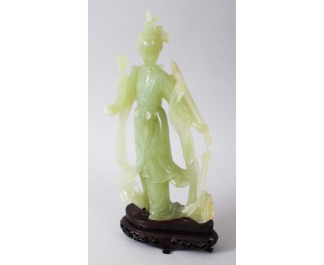 A GOOD 19TH / 20TH CENTURY CHINESE CARVED JADE FIGURE OF GUANYIN, stood in traditional robes and holding an implement, comes 