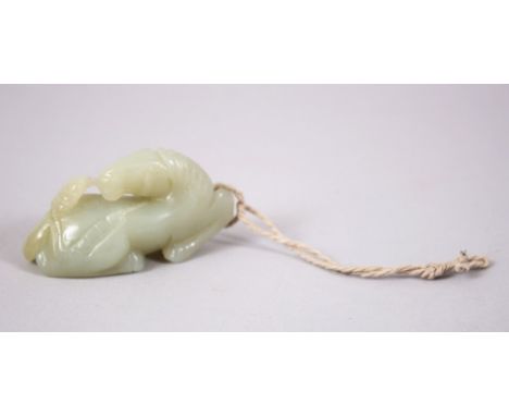 A CHINESE JADE PENDANT OF A RECUMBENT HORSE, 7cm long.