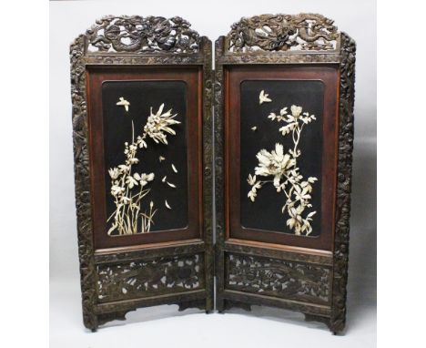 A LARGE JAPANESE MEIJI PERIOD TWO-FOLD HARDWOOD &amp; SHIBAYAMA SCREEN, , the panels decorated in high relief using carved iv