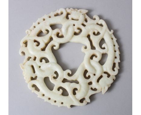 A GOOD CHINESE 19TH / 20TH CENTURY CARVED WHITE JADE ROUNDEL / BI DISK, carved to depict intertwined dragons, 14cm diameter.