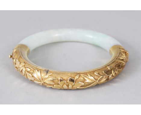 A GOOD 19TH CENTURY CHINESE GREEN JADE  &amp; GOLD BANGLE, the gold section with chiselled floral decoration and the clasp wi