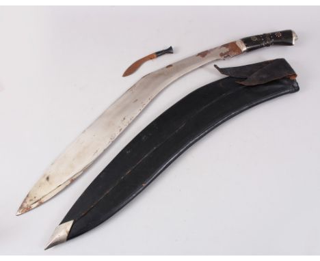 A LARGE NEPALESE KUKRI in a leather scabbard with small knife.