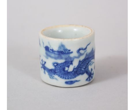 A GOOD CHINESE MING STYLE BLUE &amp; WHITE PORCELAIN FINGER RING, with decoration of a dragon amongst swirling clouds, 3cm di