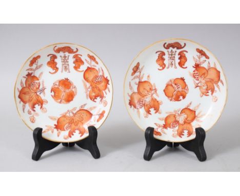 A GOOD PAIR OF CHINESE GUANGXU PERIOD IRON RED PORCELAIN SAUCERS AND STANDS, each decorated with fruiting, bats and peace mar