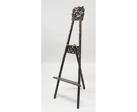 A GOOD 19TH / 20th CENTURY CHINESE CARVED HARDWOOD / ROSEWOOD EASEL, well carved to depict scenes of floral displays, the cen