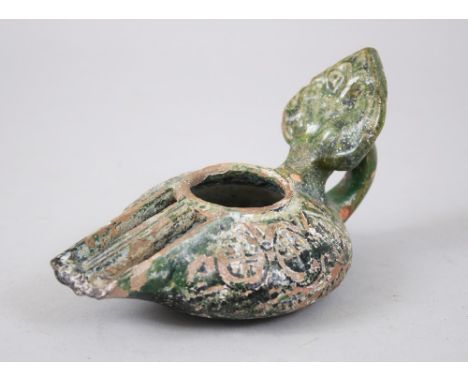 A RARE 8TH-9TH CENTURY SYRIA UMAYYAD GREEN GLAZED POTTERY OIL LAMP, 14cm long.