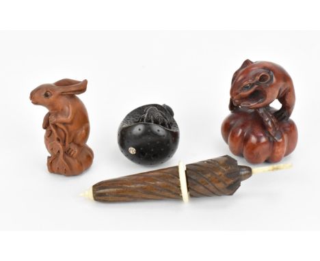 Three Japanese carved wooden netsukes, 20th century, comprising a model of a hare, a mouse, and a wasp sat on a part eaten pe