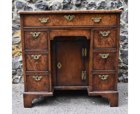 An early George III burr walnut and feather-banded kneehole desk, the bookmatched veneer top with herringbone string inlay bo