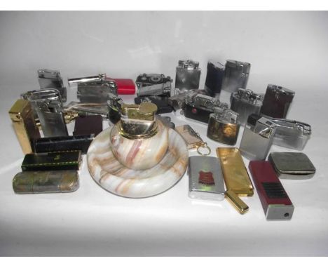 A box containing a collection of vintage cigarette lighters, further table lighters, etc