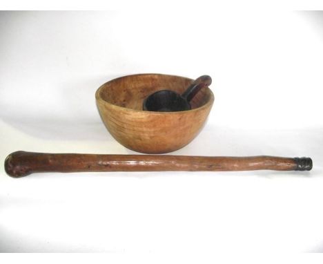 A simple polished timber cudgel with twisted metalwork collar to the foot together with a large hewn timber bowl and a simple