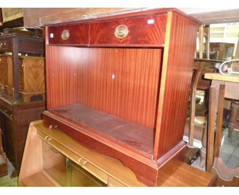 A dwarf reproduction mahogany veneered bookcase in the Georgian style with open shelf beneath two frieze drawers with well ma