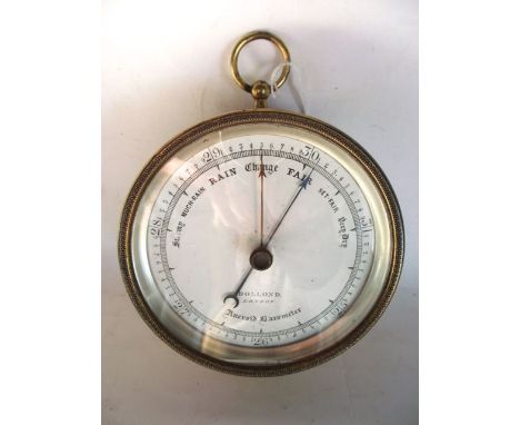 A good quality brass cased circular aneroid barometer by Dollond of London, 12 cm diameter approx