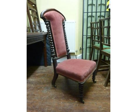 A Victorian walnut side chair in the gothic manner with axe shape outline supported on a pair of tapering spiral twist suppor