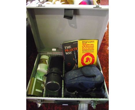 A contemporary aluminium case containing vintage photographic equipment to include a Praktica camera, a cased Sigma lens, a f