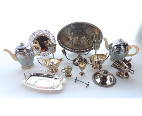 A silver plated tray of oval form with pierced gallery and embossed detail, a plated milk jug, sugar basin, two  goblets, a H