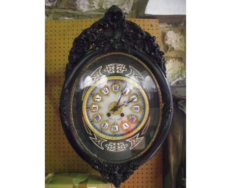 A 19th century French vineyard clock, the oviform case with applied and moulded floral detail, the dial with applied enamel n