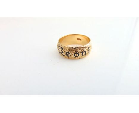 A 14ct gold ring, the engraved band with black enamel reading "Keoni", meaning John in Hawaiian, 10g, size U