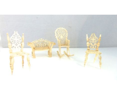 Four 19th century miniature ivory items of furniture - rocking chair, sofa and two chairs, all with pierced seats and backs, 