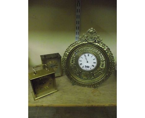 A Victorian cast brass table or easel clock with pierced decoration and 8-day timepiece, together with two 20th century carri