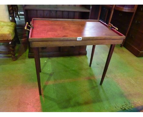 A vintage butlers tray/table of rectangular form with fold away legs and brass carrying handles