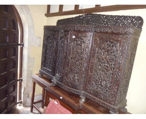 A 19th century Anglo Indian side cupboard, the base enclosed by four arched and panelled doors with bow fronted centre set be