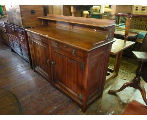 A good quality Victorian oak sideboard in the gothic manner, the base enclosed by two doors each with linen fold panels, toge