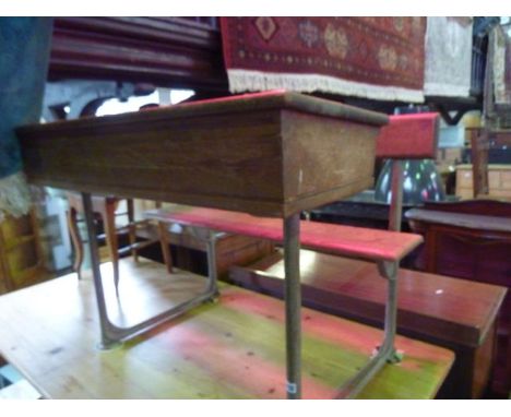 A vintage steel framed school desk for two pupils with oak writing slope, plank seat and back rail