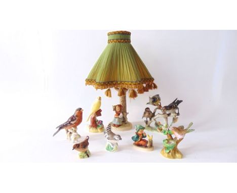 A Goebel Hummel lamp base in the form of a tree trunk with applied figures of a little girl and a lamb, with impressed number