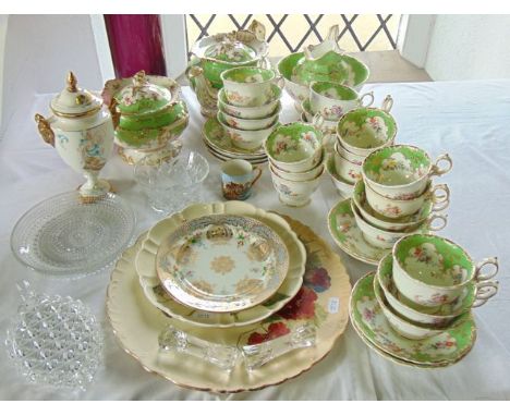 An extensive collection of 19th century tea wares with green and gilt border decoration and printed and infilled floral spray