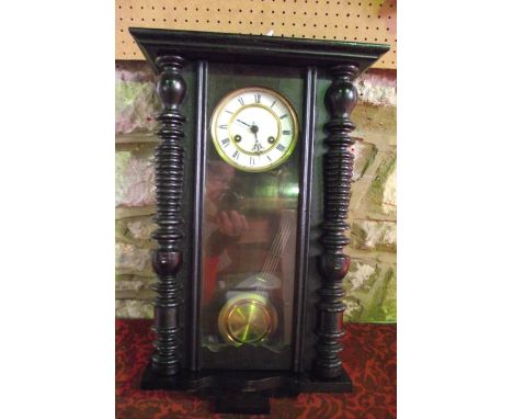 A late 19th century wall clock, the case with split spindle mouldings and enclosing an 8-day striking movement