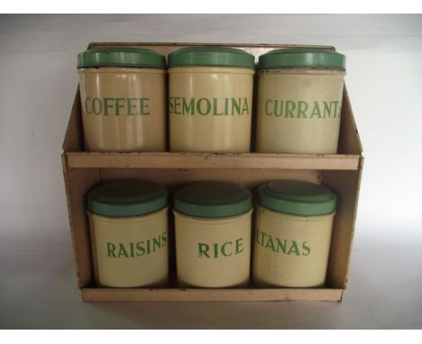 A vintage set of six Tala painted metallic storage jars with cream ground and green lids and text to include coffee, semolina