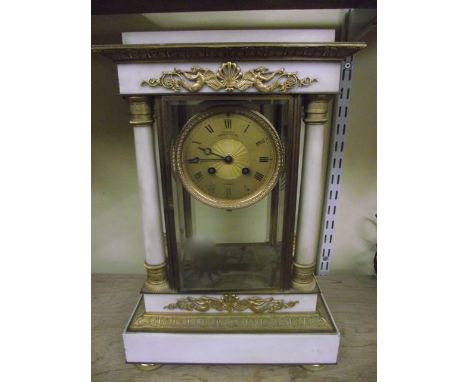 A Regency period white marble and gilt brass portico mantel clock, the 8-day striking movement enclosed by four glass panels