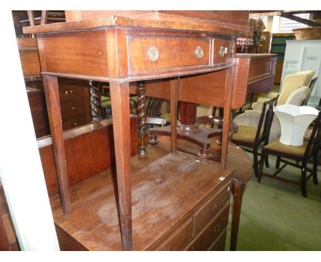 A 19th century mahogany two drawer side table in the Georgian style with bow fronted outline raised on four square tapered le