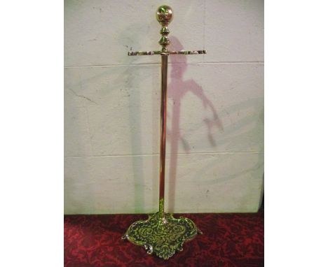 A good quality antique brass stick stand with scrolling embossed base, 73 cm tall approx