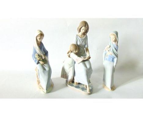 A Lladro Daisa group of a girl reading to a younger child with printed and impressed mark to base numbers 5457 together with 