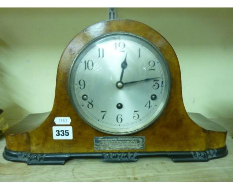 An Art Deco figured walnut mantel clock with 3-train movement, with presentation plaque dated 1932 