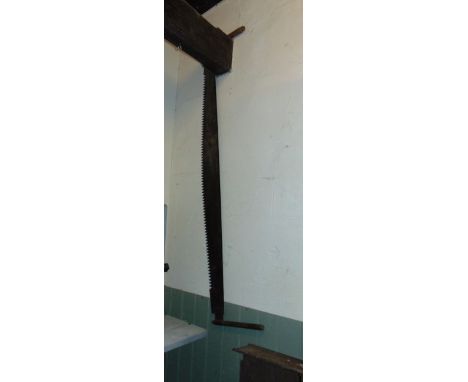 A vintage two-man saw with wooden handles