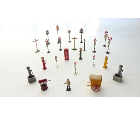 A collection of vintage painted lead model street furniture to include signage, telephone box, petrol pump, lamp, waymarker, 