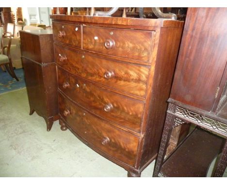 A Victorian mahogany bow fronted bedroom chest of three long and two short graduated drawers with flame veneers, turned knob 