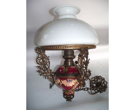 An electronic ceiling light (converted) with central ceramic fount with foliate detail and extensive brass framework supporti
