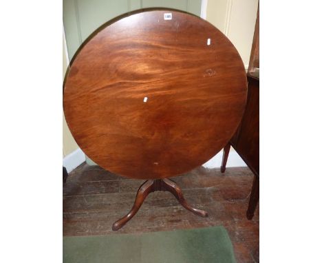 A 19th century mahogany snap top table on turned and fluted vase shaped pillar, tripod base, with further carved detail, sing