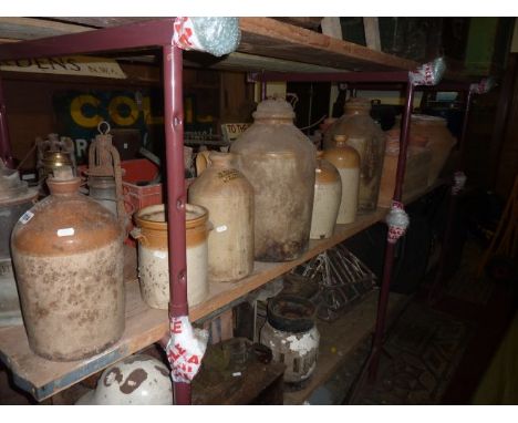 A collection of vintage stoneware jars and flagons, two with impressed merchants marks for L Price, Nailsworth and F J & W Vi